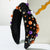 Wide Knotted Halloween Headband Embellished with Festive Pumpkins
