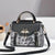 Intricate Pattern Metal Swan Embellishment Top Handle Shoulder Bag