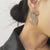 Shimmer and Shine Oversized Rhinestone Dollar Money Sign Drop Earrings